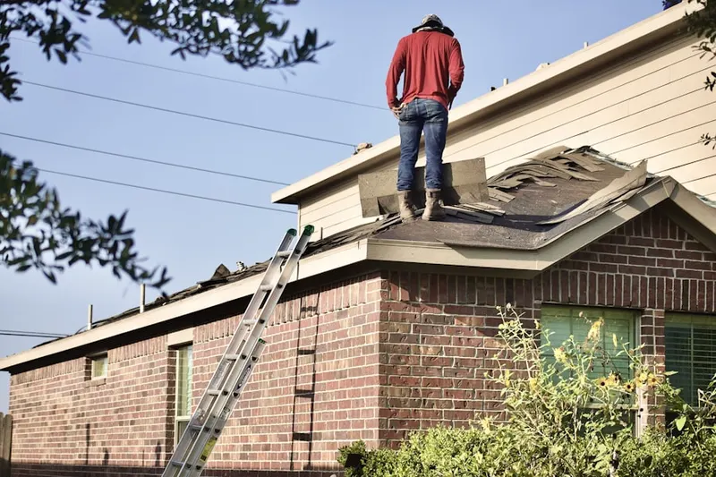 Professional roofer working on a residential roof in Chesapeake Beach